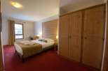 Cozy and inviting bedroom featuring a comfortable bed with a stylish headboard.