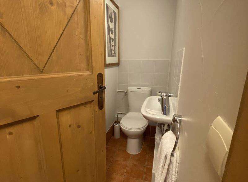 Step into this charming powder room, featuring a classic toilet and a convenient sink.