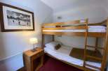 Cozy bedroom featuring a bunk bed, perfect for families or groups.