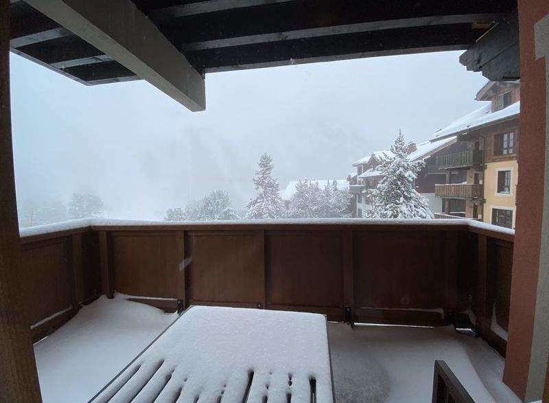 Enjoy breathtaking mountain views from this cozy balcony, perfect for a snowy getaway.