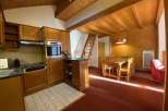 This charming property boasts a cozy kitchen with wooden cabinetry and modern appliances.