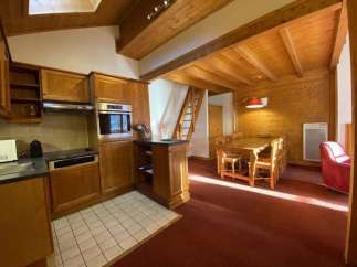 This charming property boasts a cozy kitchen with wooden cabinetry and modern appliances.