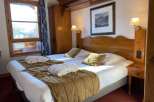 Cozy up in this charming hotel room featuring two comfortable beds, perfect for a relaxing getaway.