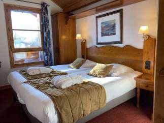 Cozy up in this charming hotel room featuring two comfortable beds, perfect for a relaxing getaway.