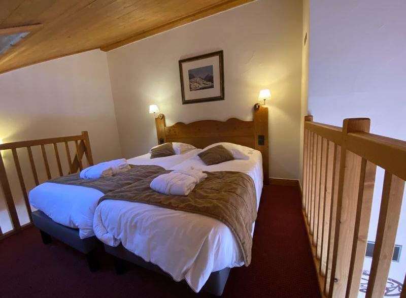 Cozy and inviting bedroom with a rustic wooden headboard and warm lighting.