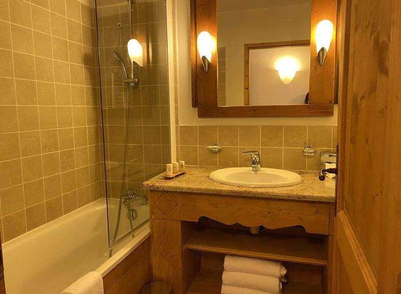 This charming bathroom features a combination of a bathtub and a shower, offering versatility for your relaxation.