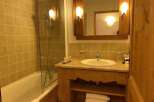 This charming bathroom features a combination of a bathtub and a shower, offering versatility for your relaxation.
