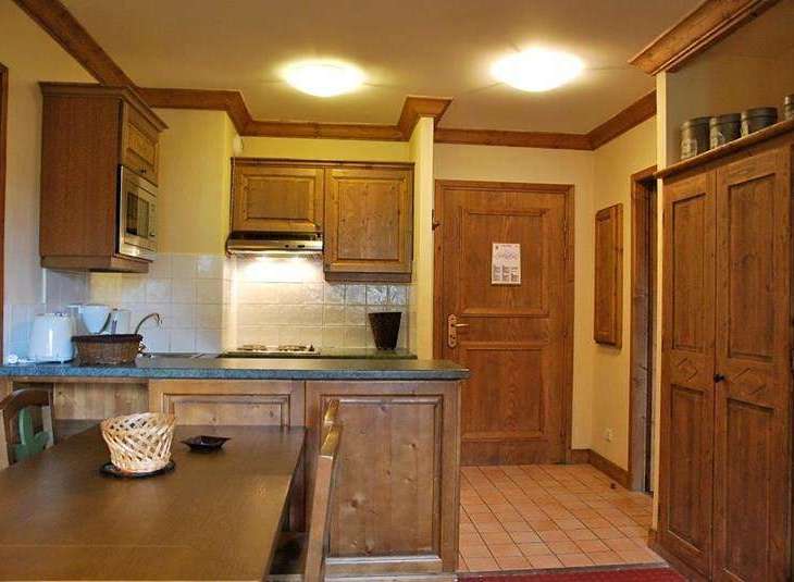 Cozy kitchen with wooden cabinets and a dining area.