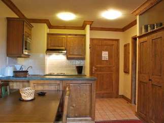 Cozy kitchen with wooden cabinets and a dining area.