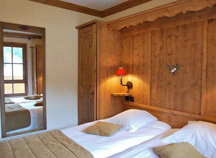 Cozy bedroom with wooden accents and a warm ambiance.