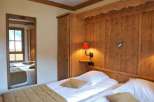 Cozy bedroom with wooden accents and a warm ambiance.