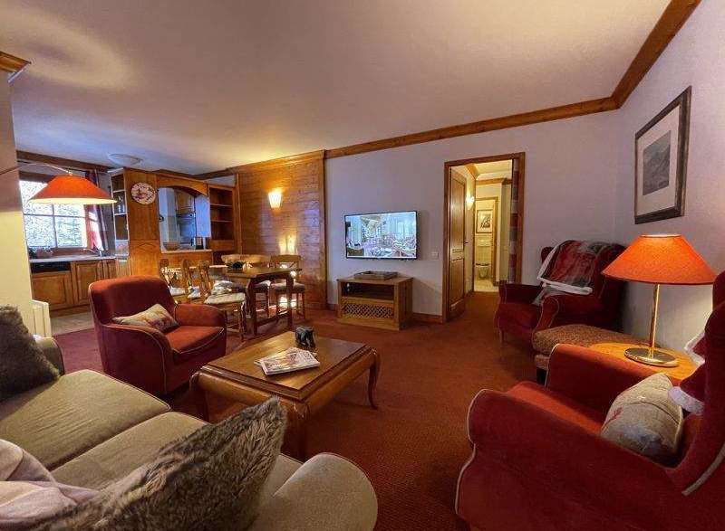 Cozy living space with a warm ambiance, featuring comfortable seating and a charming fireplace.