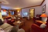 Cozy living space with a warm ambiance, featuring comfortable seating and a charming fireplace.