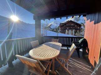 Enjoy breathtaking mountain views from this charming balcony.