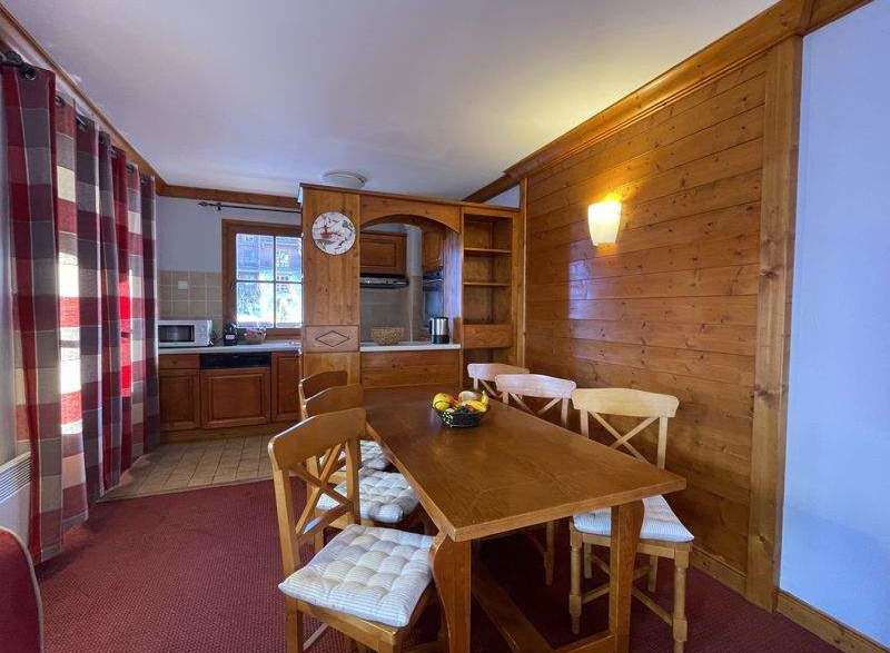 Cozy dining area with a rustic wooden table and chairs, perfect for enjoying meals.