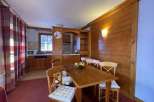 Cozy dining area with a rustic wooden table and chairs, perfect for enjoying meals.