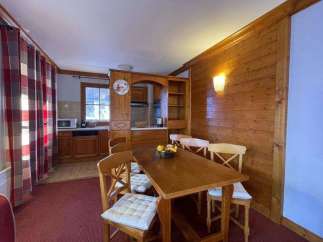 Cozy dining area with a rustic wooden table and chairs, perfect for enjoying meals.