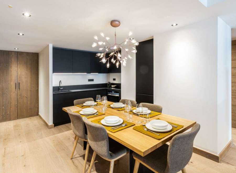 Modern apartment with open-plan kitchen and dining area.