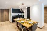 Modern apartment with open-plan kitchen and dining area.