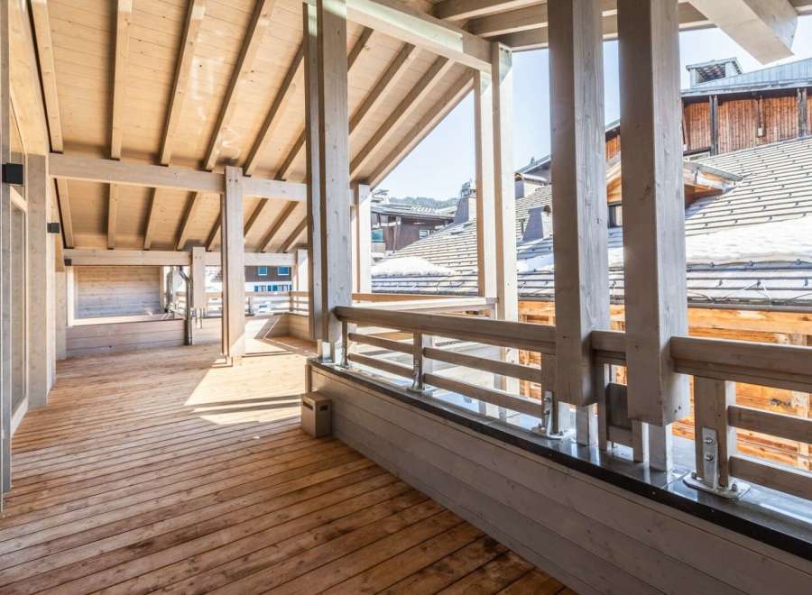 This stunning property boasts a spacious wooden deck perfect for enjoying mountain views.
