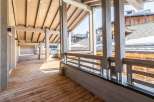 This stunning property boasts a spacious wooden deck perfect for enjoying mountain views.