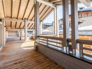 This stunning property boasts a spacious wooden deck perfect for enjoying mountain views.