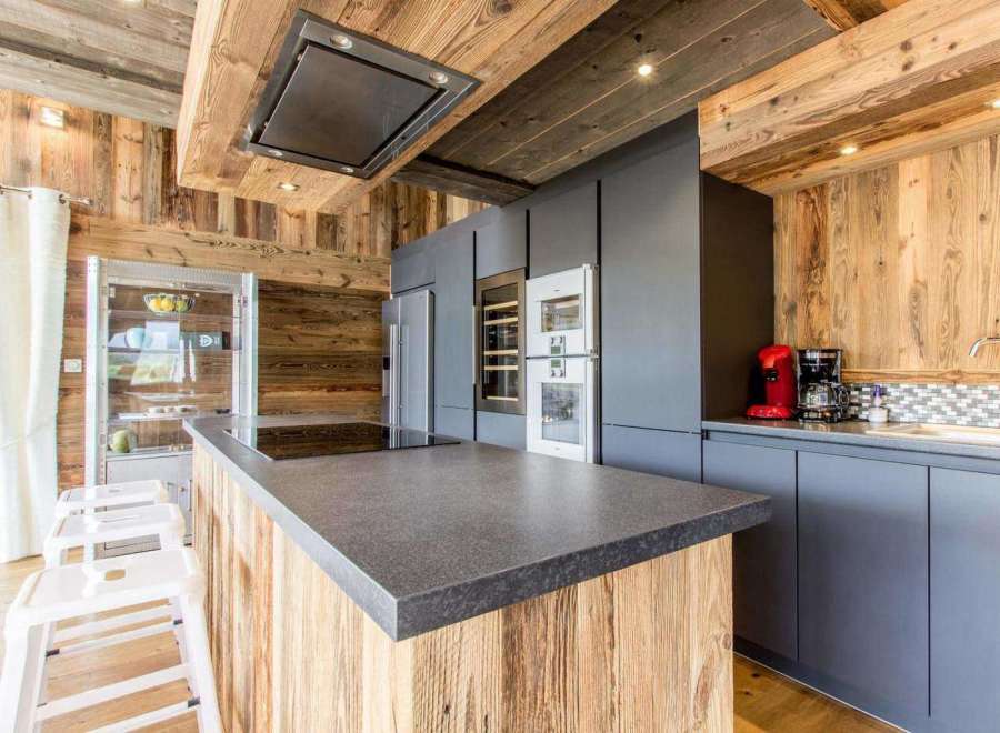 This stunning kitchen boasts a rustic charm with its wooden accents and modern appliances.