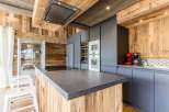 This stunning kitchen boasts a rustic charm with its wooden accents and modern appliances.