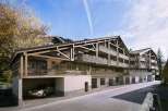 This stunning chalet-style apartment building boasts spacious balconies with intricate metalwork, offering breathtaking views.