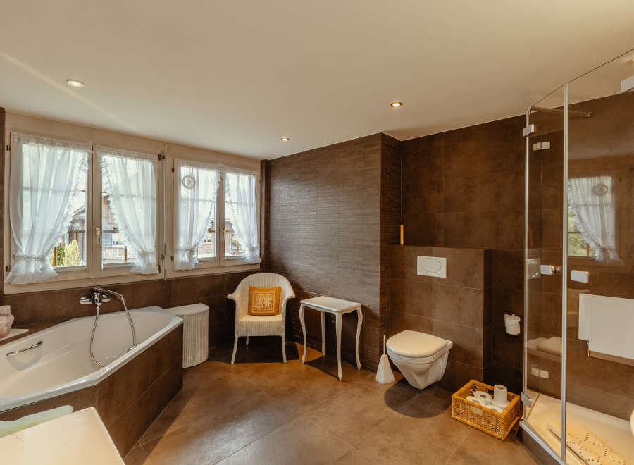 This luxurious bathroom features a modern design with a touch of rustic charm.