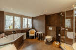 This luxurious bathroom features a modern design with a touch of rustic charm.