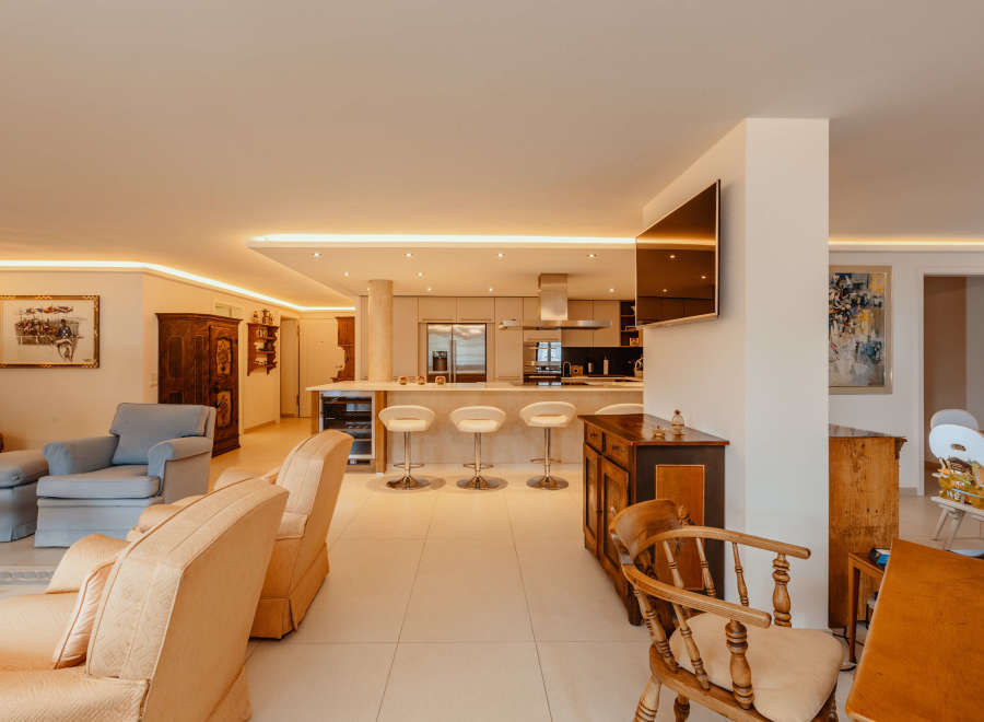 Step into luxury with this stunning property, featuring a modern kitchen with sleek appliances and a breakfast bar.