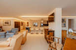 Step into luxury with this stunning property, featuring a modern kitchen with sleek appliances and a breakfast bar.