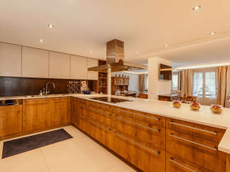 This stunning kitchen boasts a modern design with sleek wooden cabinetry and a spacious layout.