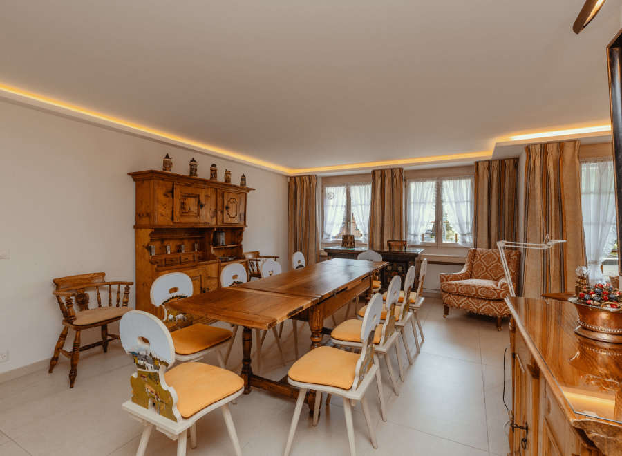 Step into a charming dining room with a rustic wooden table and chairs, perfect for gatherings.