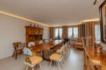 Step into a charming dining room with a rustic wooden table and chairs, perfect for gatherings.