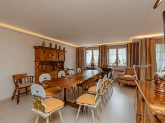 Step into a charming dining room with a rustic wooden table and chairs, perfect for gatherings.