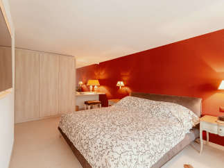 This cozy bedroom features a comfortable bed with a unique patterned duvet.