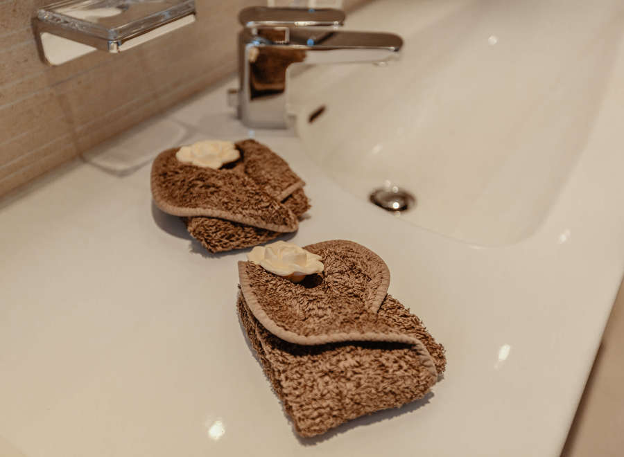 Indulge in the luxurious comfort of this bathroom, featuring elegant towels and a pristine sink.