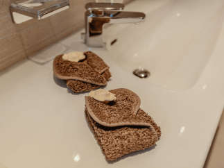 Indulge in the luxurious comfort of this bathroom, featuring elegant towels and a pristine sink.
