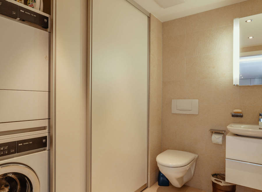 This modern bathroom features a sleek design with neutral tones and ample natural light.