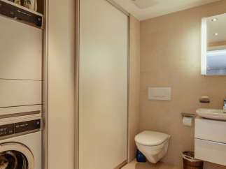 This modern bathroom features a sleek design with neutral tones and ample natural light.