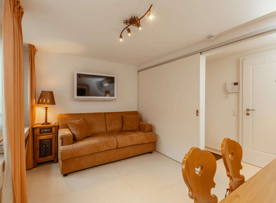 This cozy living space features a comfortable brown sofa, perfect for relaxing.