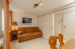 This cozy living space features a comfortable brown sofa, perfect for relaxing.