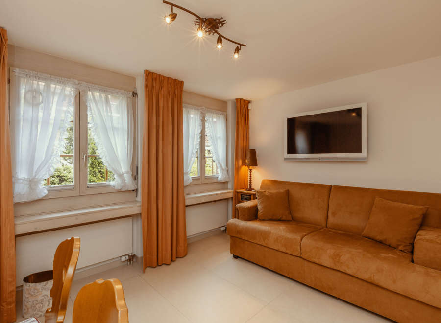 This cozy living space features a comfortable sofa, perfect for relaxing.