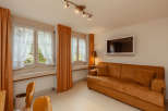 This cozy living space features a comfortable sofa, perfect for relaxing.