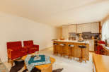 This stunning property boasts a modern kitchen with a stylish island and comfortable seating.
