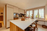 This stunning kitchen boasts a modern design with a spacious island, perfect for culinary creations and casual dining.