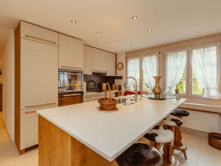 This stunning kitchen boasts a modern design with a spacious island, perfect for culinary creations and casual dining.