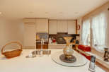 This bright and airy kitchen features modern cabinetry and a sleek countertop, perfect for culinary enthusiasts.